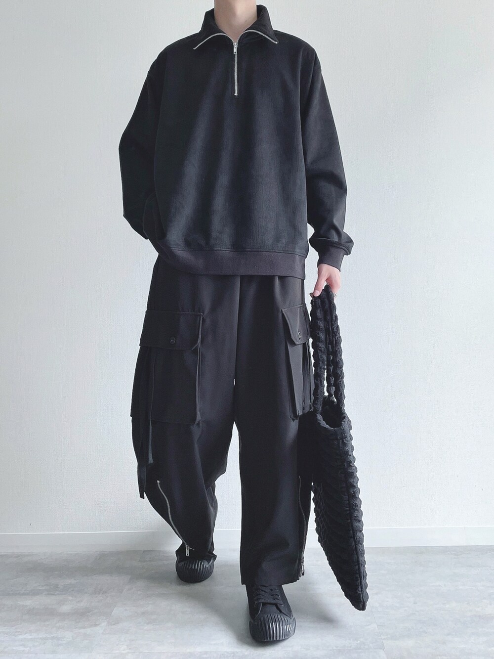 ブラック系のスウェット、ブラック系のカーゴパンツ、ブラック系のスニーカーを着用したメンズの冬コーディネートの2枚目の写真