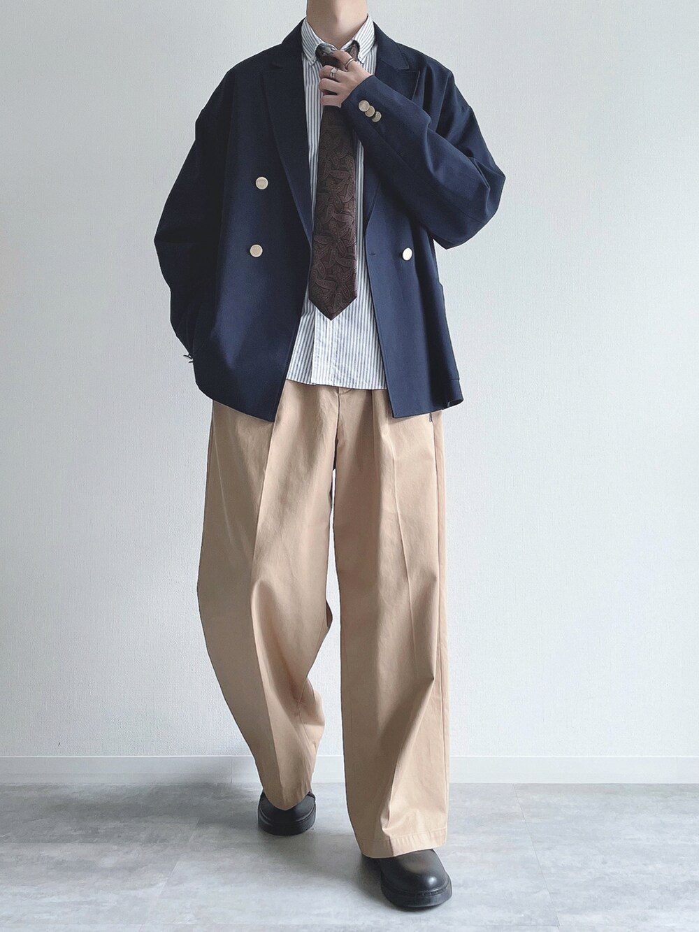 ブルー系のテーラードジャケット、ホワイト系のシャツ/ブラウス、ベージュ系のチノパンツを着用したメンズの秋コーディネートの2枚目の写真