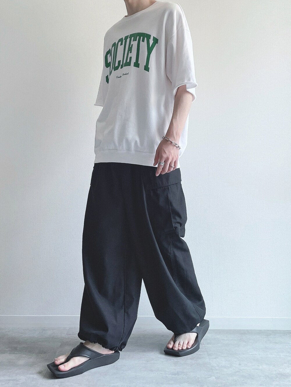 ホワイト系のTシャツ/カットソー、ブラック系のその他パンツ、ブラック系のサンダルを着用したメンズの夏コーディネートの5枚目の写真