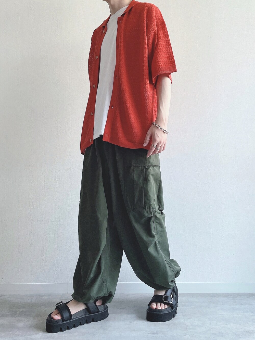 オレンジ系のシャツ/ブラウス、ホワイト系のTシャツ/カットソー、グリーン系のカーゴパンツを着用したメンズの夏コーディネートの5枚目の写真