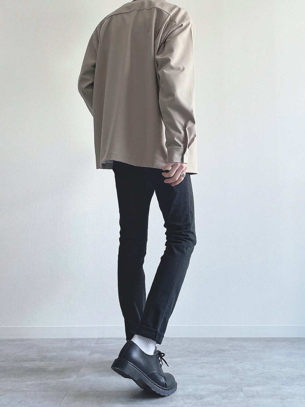 ベージュ系のトップス、ホワイト系のTシャツ/カットソー、ブラック系のパンツを着用したメンズの春コーディネートの3枚目の写真