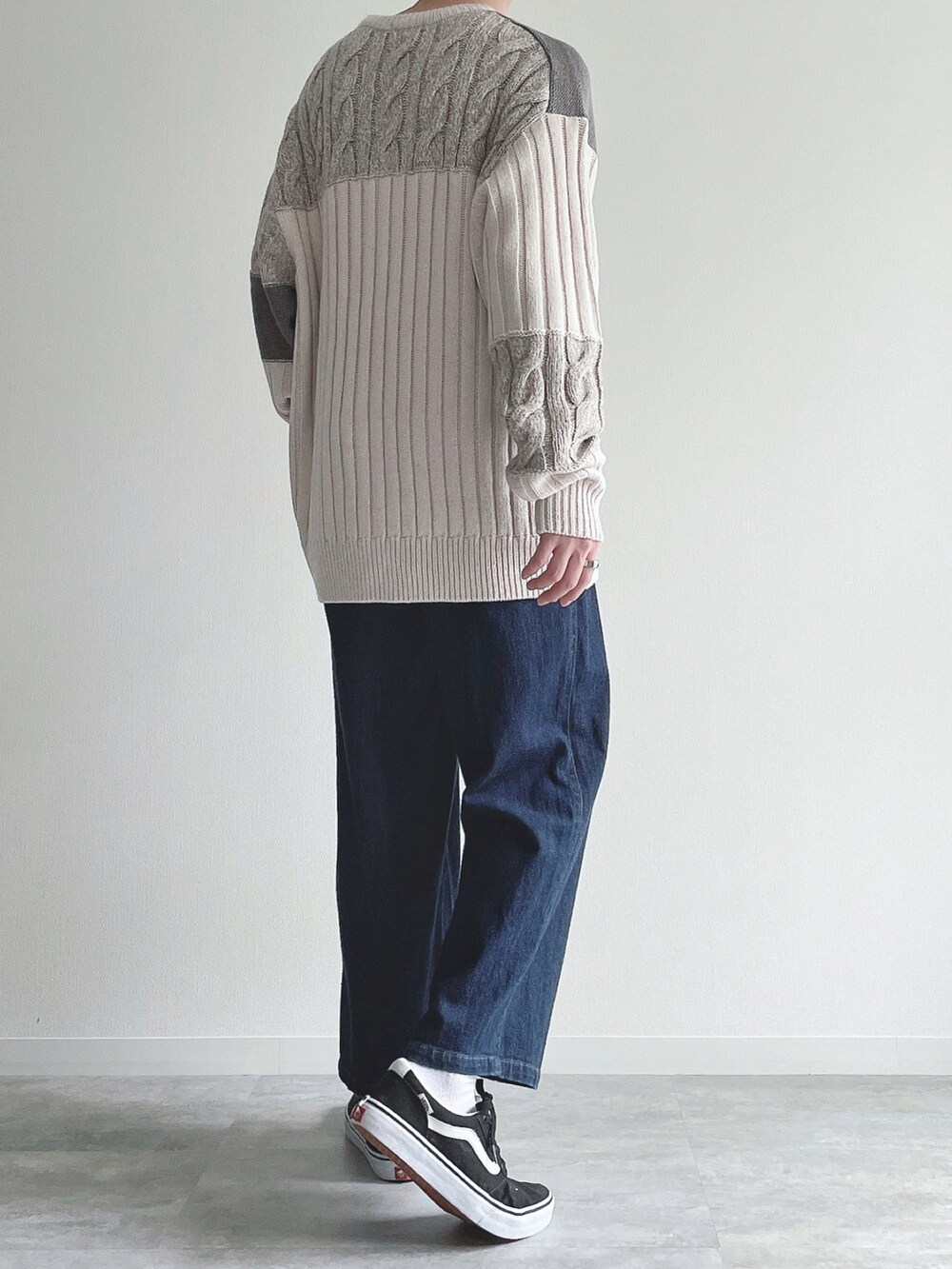 ホワイト系のニット/セーター、ブルー系のその他パンツ、ブラック系のスニーカーを着用したメンズの冬コーディネートの4枚目の写真