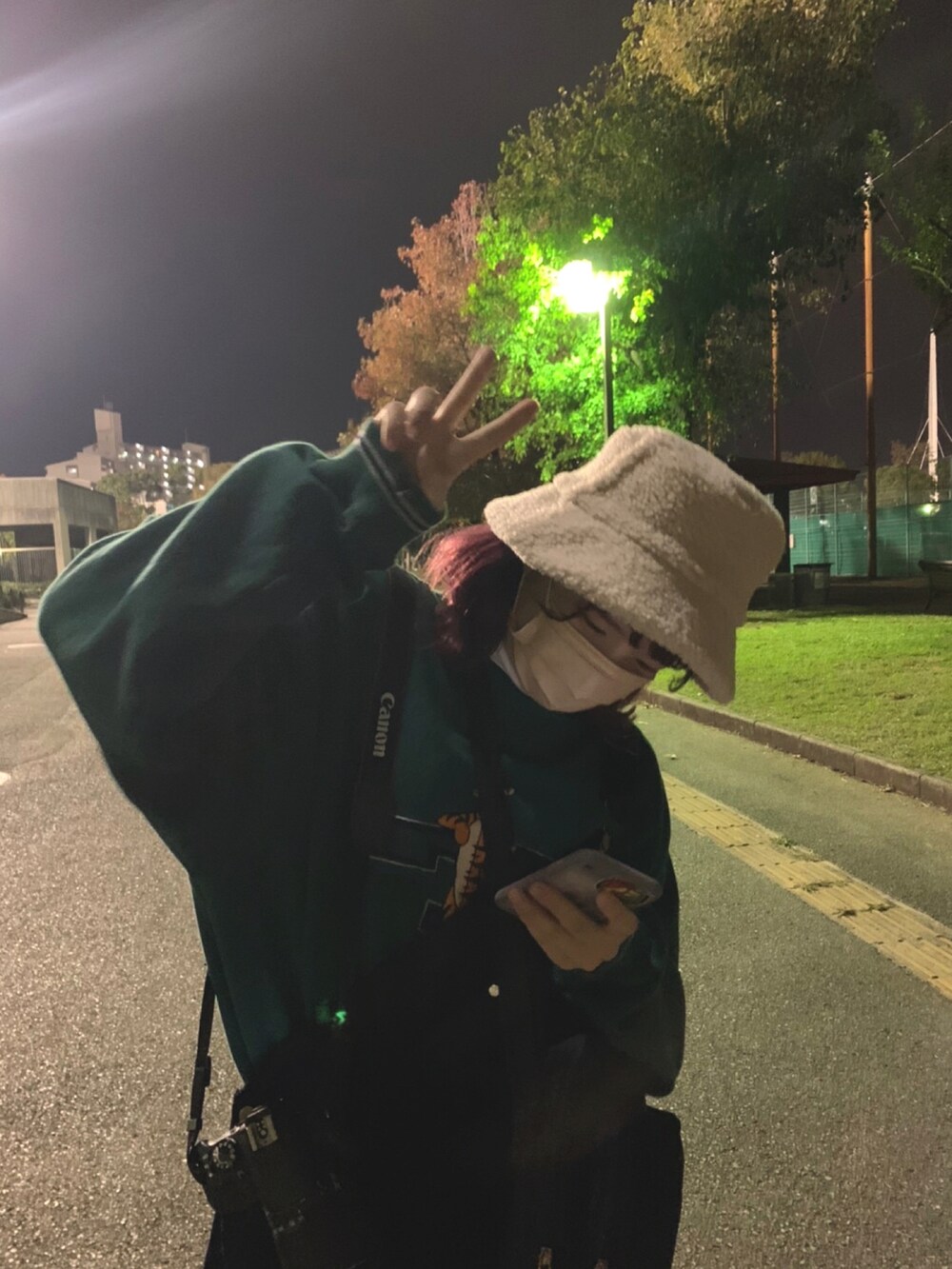 ブラック系のサロペット/オーバーオール、ブラック系のショルダーバッグ、ホワイト系のスニーカーを着用したレディースの秋コーディネートの2枚目の写真