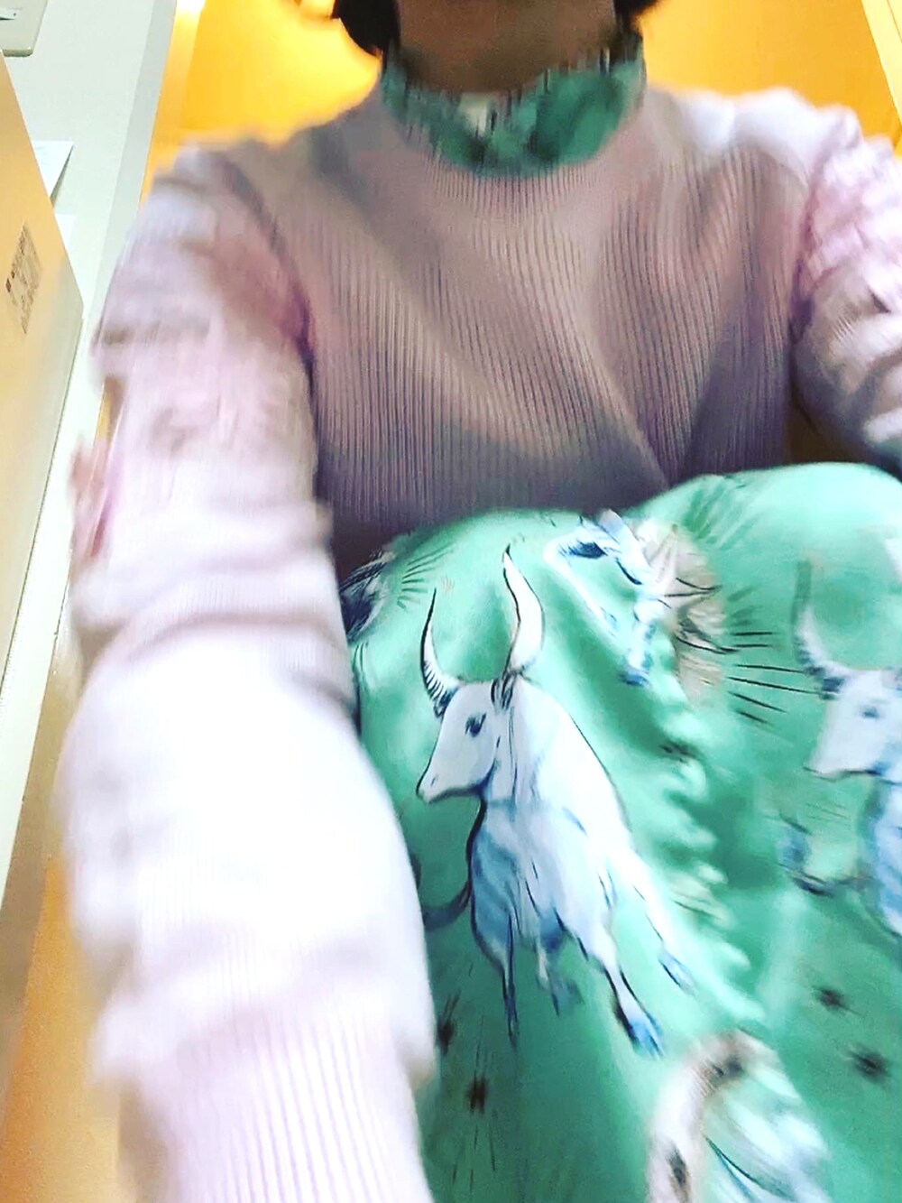 ピンク系のニット/セーター、グリーン系のワンピース、シルバー系のダウンジャケット/コートを着用したレディースの冬コーディネートの3枚目の写真