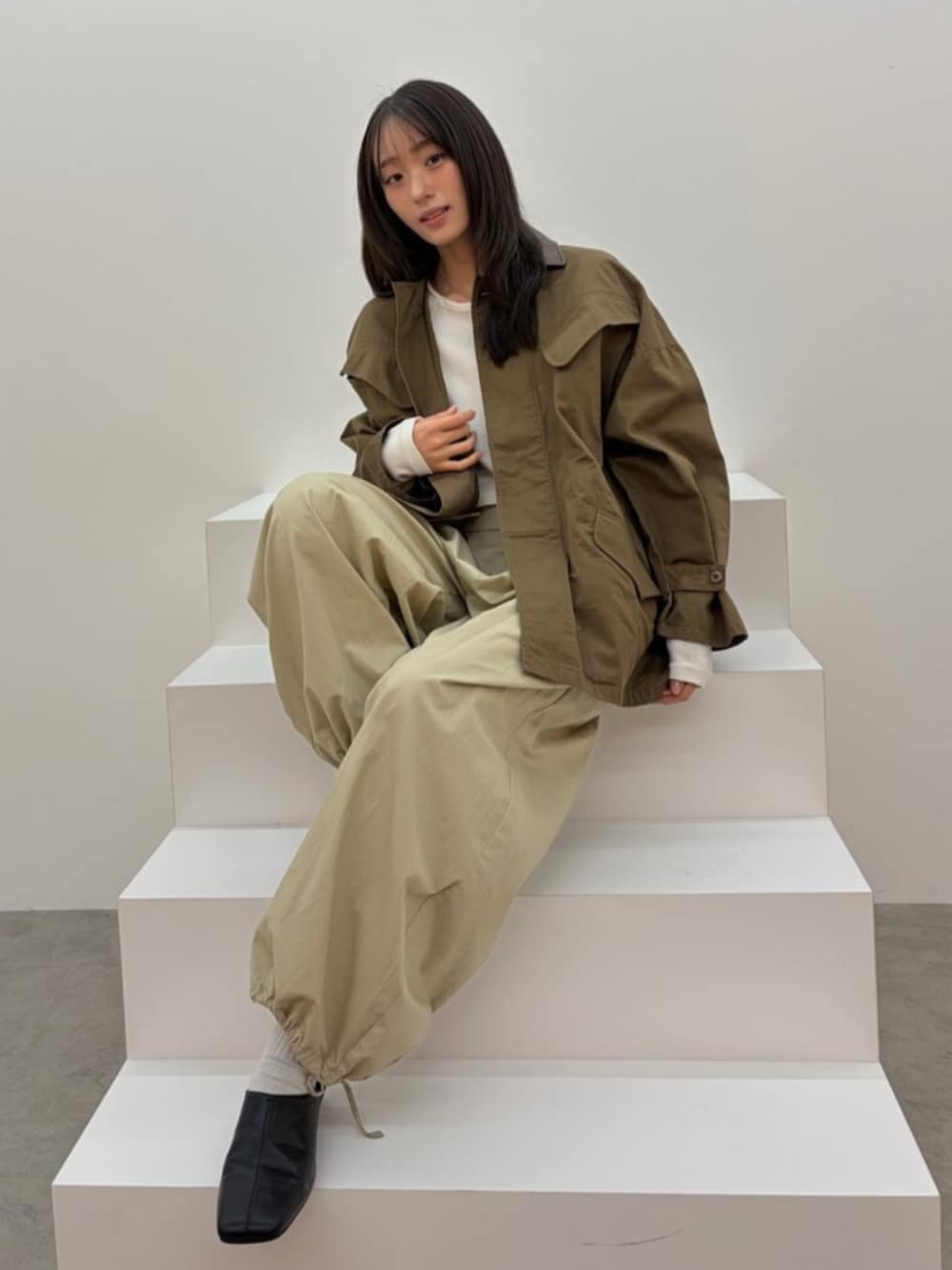 グレー系のTシャツ/カットソー、ブラウン系のブルゾン、ベージュ系のその他パンツを着用したレディースの春コーディネートの2枚目の写真