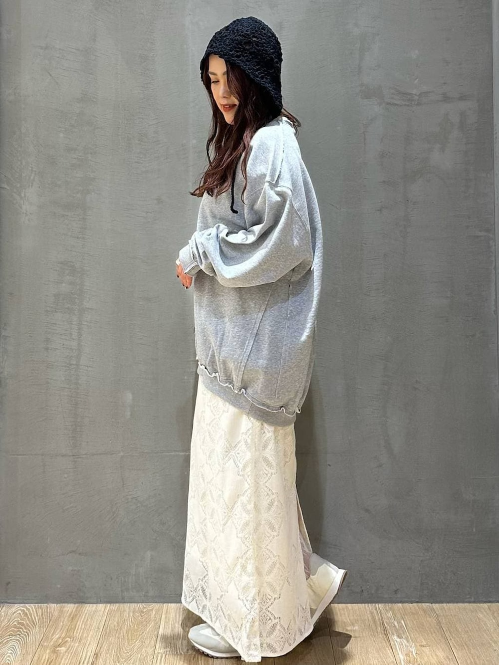 ホワイト系のスカート、グレー系のスウェット、ホワイト系のスニーカーを着用したレディースの冬コーディネートの2枚目の写真