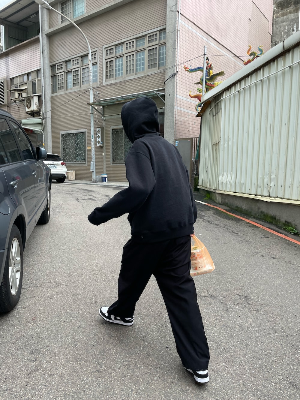 ブラック系のパーカー、ブラック系のパーカー、ブラック系のスニーカーを着用したメンズの春コーディネートの2枚目の写真