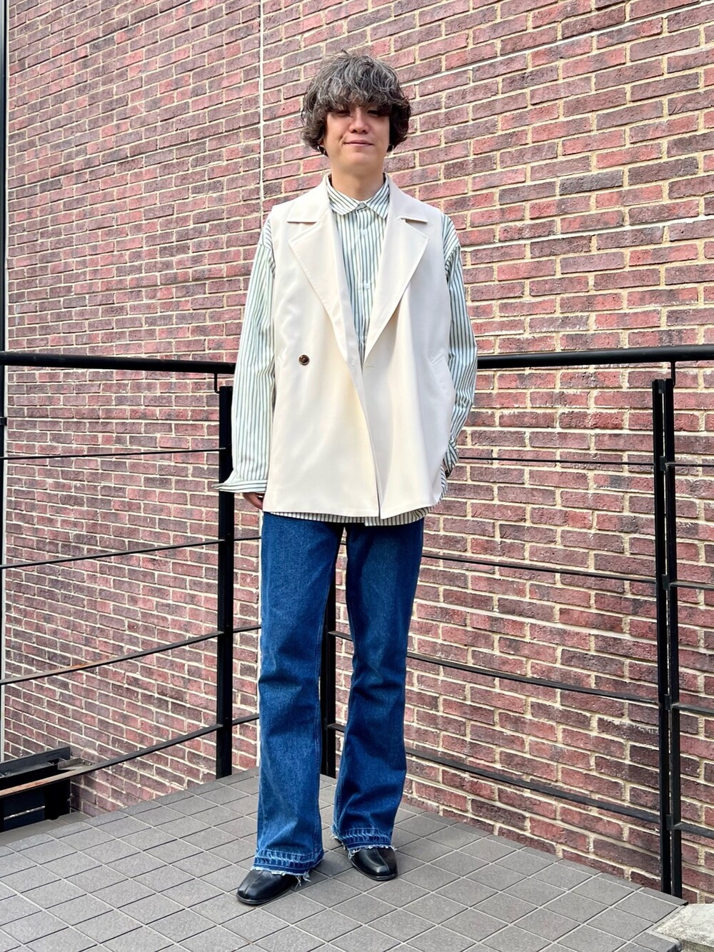 ベージュ系のベスト、グリーン系のシャツ/ブラウス、ブルー系のデニムパンツを着用したメンズの夏コーディネートの2枚目の写真