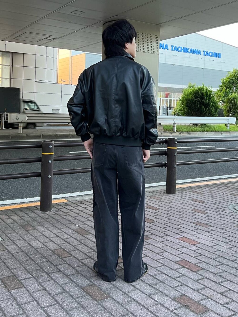 ブラック系のデニムパンツ、ブラック系のブルゾンを着用したメンズの夏コーディネートの3枚目の写真