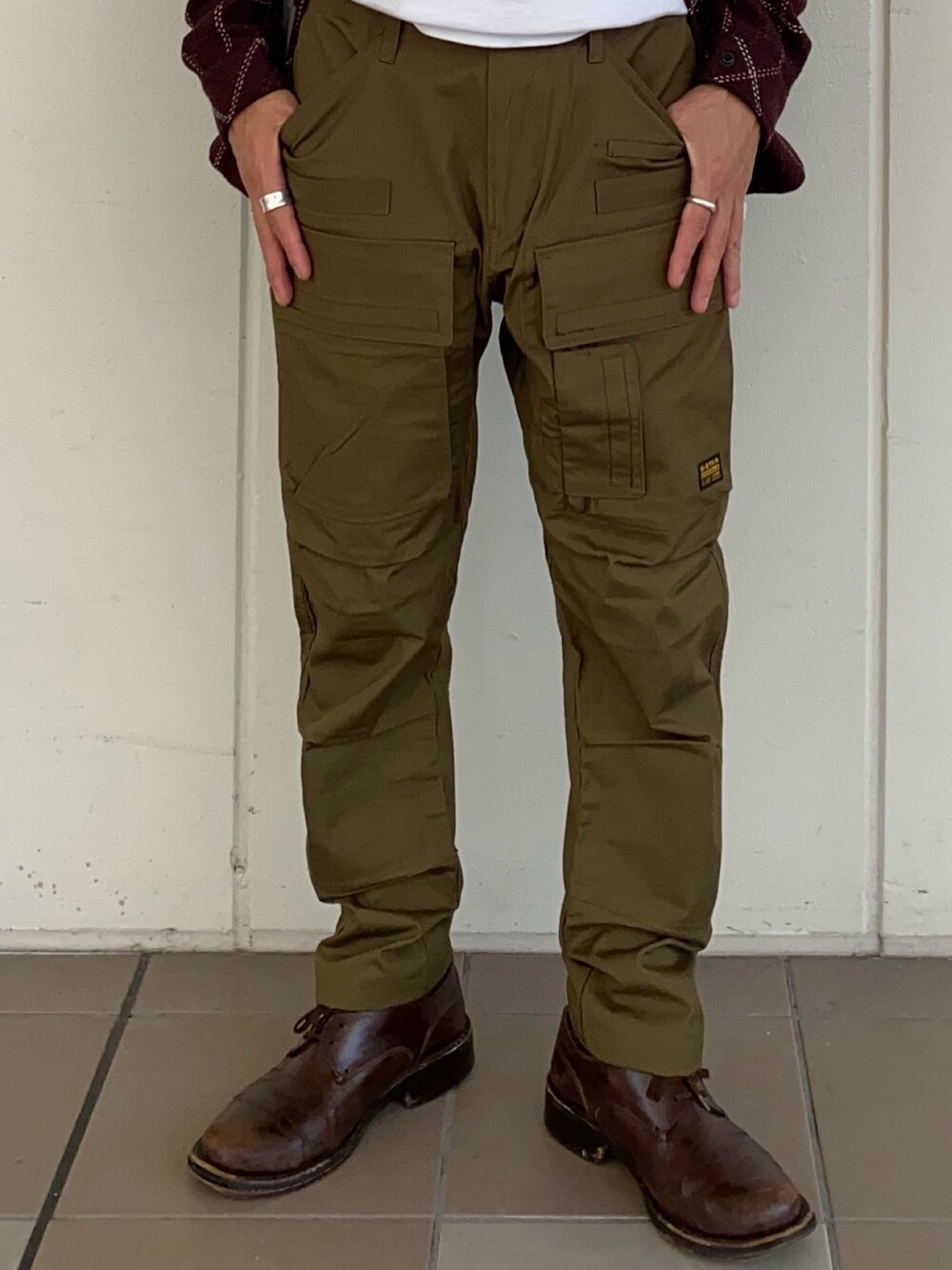 レッド系のブルゾン、グリーン系のカーゴパンツを着用したメンズの秋コーディネートの3枚目の写真