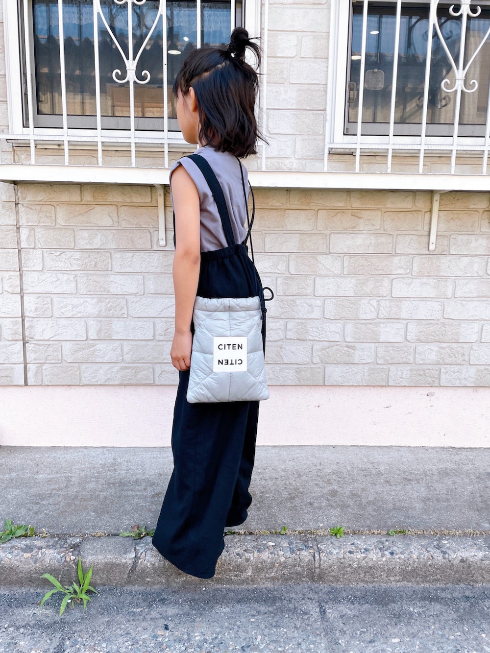 グレー系のショルダーバッグ、グレー系のTシャツ/カットソー、ピンク系のスニーカーを着用したキッズの夏コーディネートの4枚目の写真