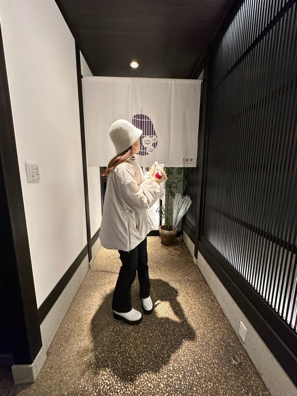 ブラック系のサロペット/オーバーオール、ホワイト系のノーカラージャケット、ブラウン系のショルダーバッグを着用したレディースの夏コーディネートの2枚目の写真