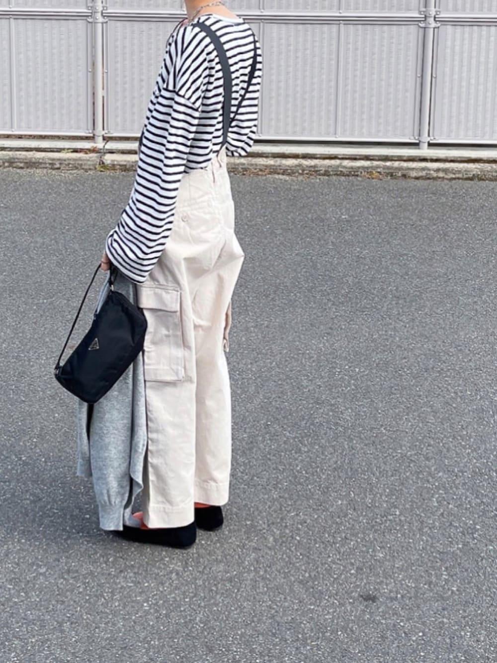 グレー系のカーディガン/ボレロ、ブラック系のハンドバッグを着用したレディースの冬コーディネートの2枚目の写真