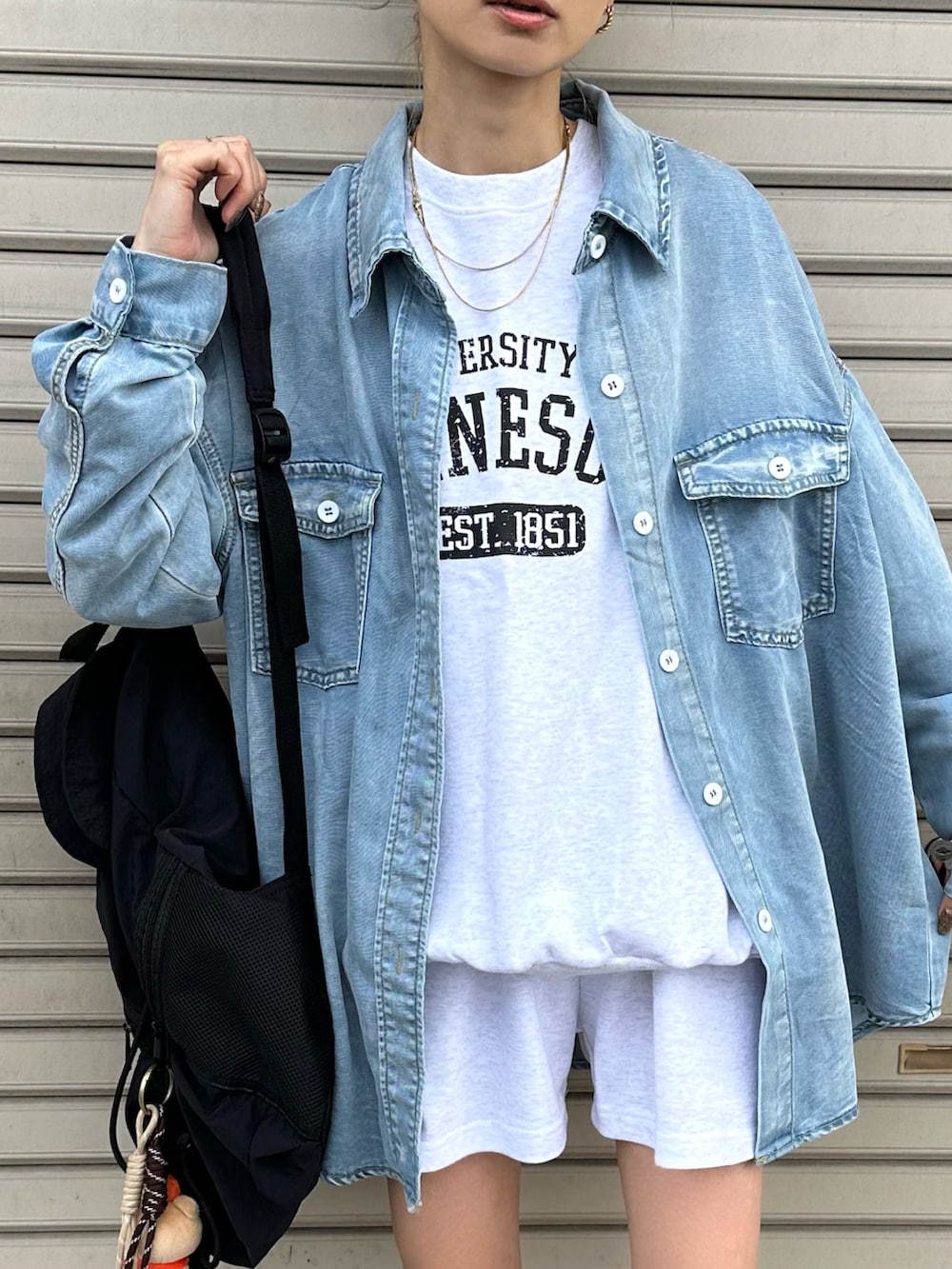 グレー系のスニーカー、ブルー系のシャツ/ブラウスを着用したレディースの春コーディネートの2枚目の写真