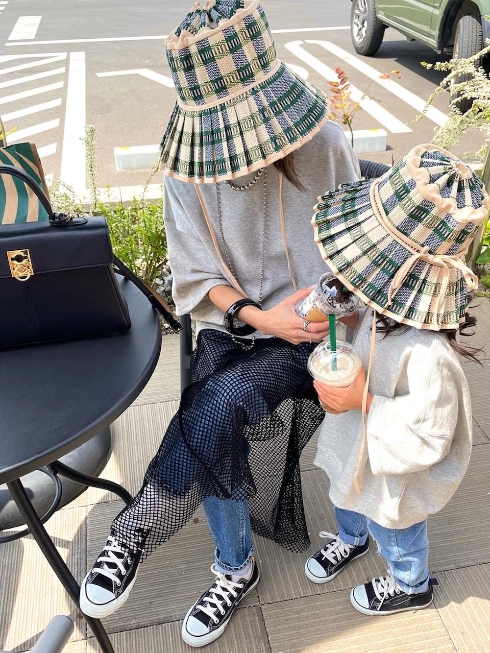 ブラック系のワンピースを着用したレディースの春コーディネートの2枚目の写真