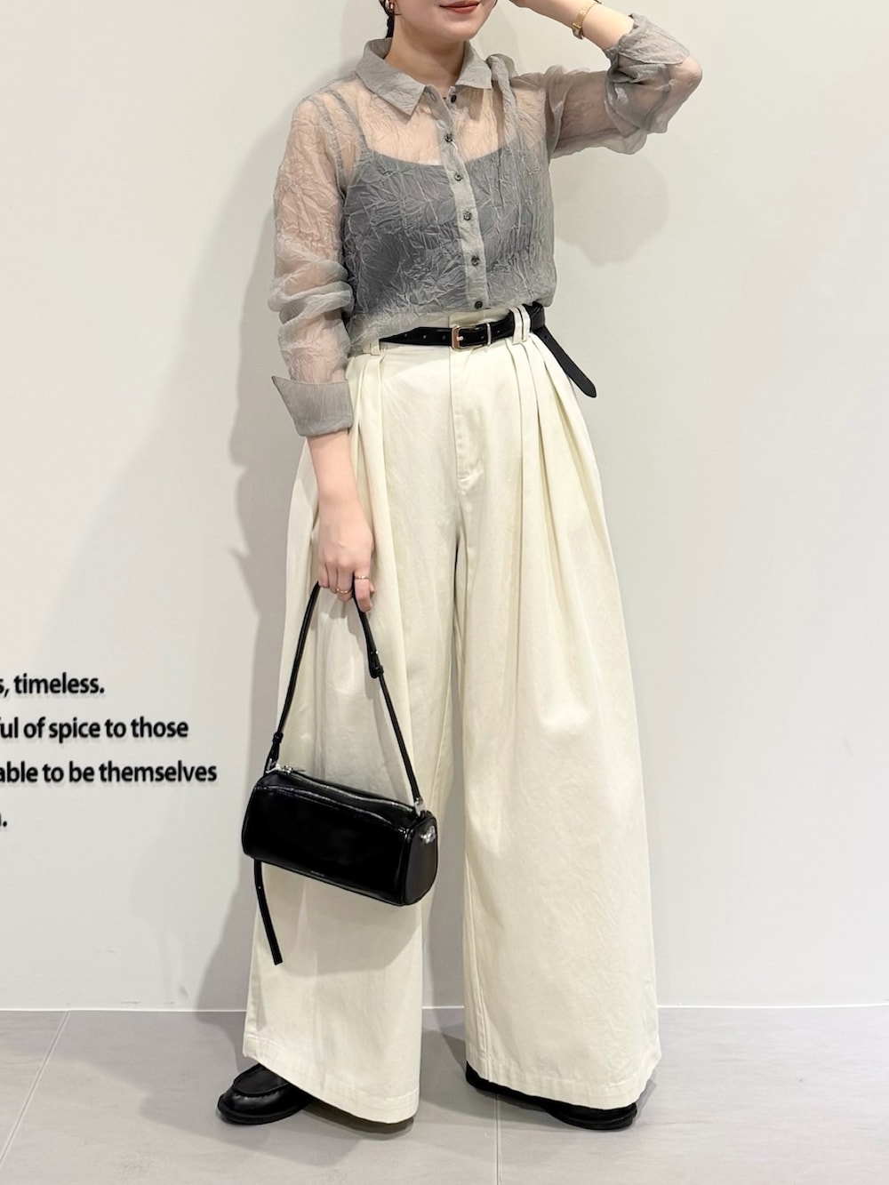 グレー系のシャツ/ブラウス、ホワイト系のその他パンツ、ブラック系のショルダーバッグを着用したレディースの春コーディネートの3枚目の写真