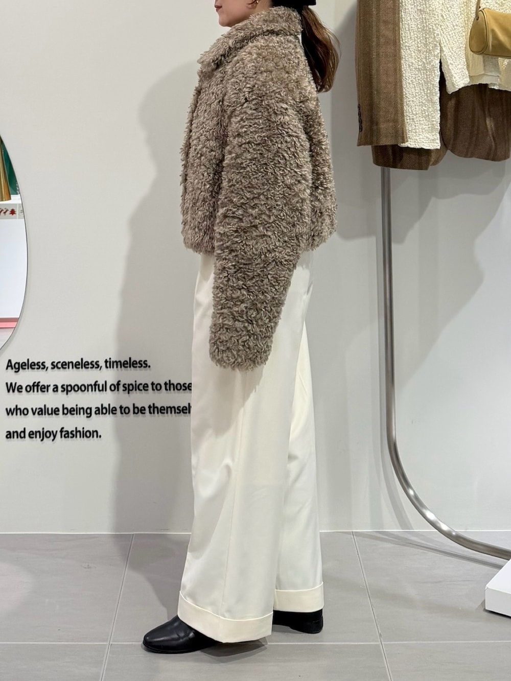 ベージュ系のその他アウター、ホワイト系のその他パンツ、ブラック系のショルダーバッグを着用したレディースの秋コーディネートの3枚目の写真