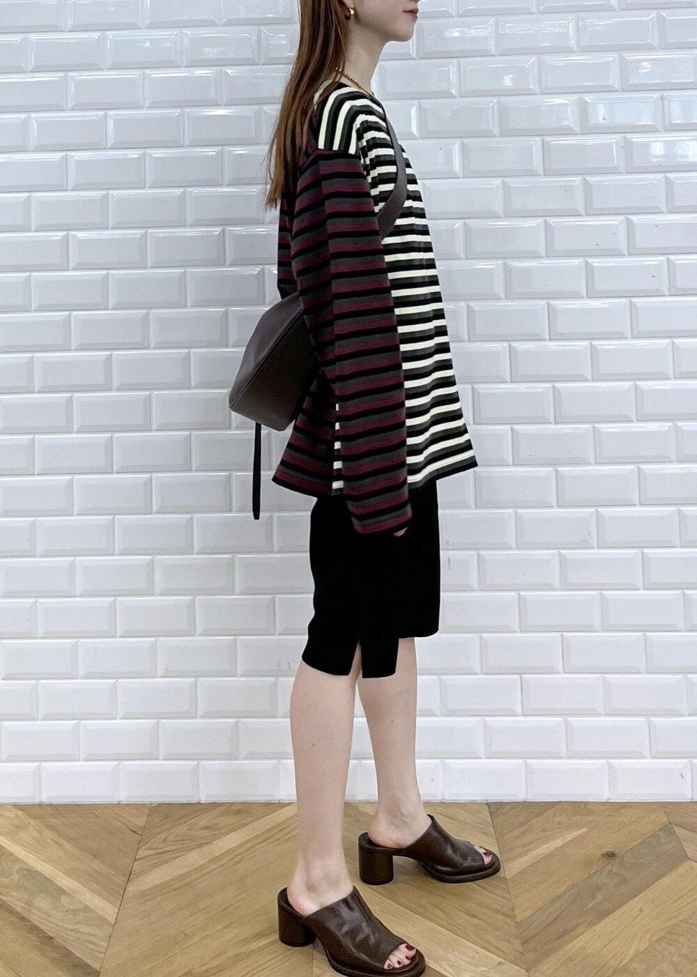 ブラウン系のサンダル、ブラック系のその他パンツ、レッド系のショルダーバッグを着用したレディースの秋コーディネートの4枚目の写真