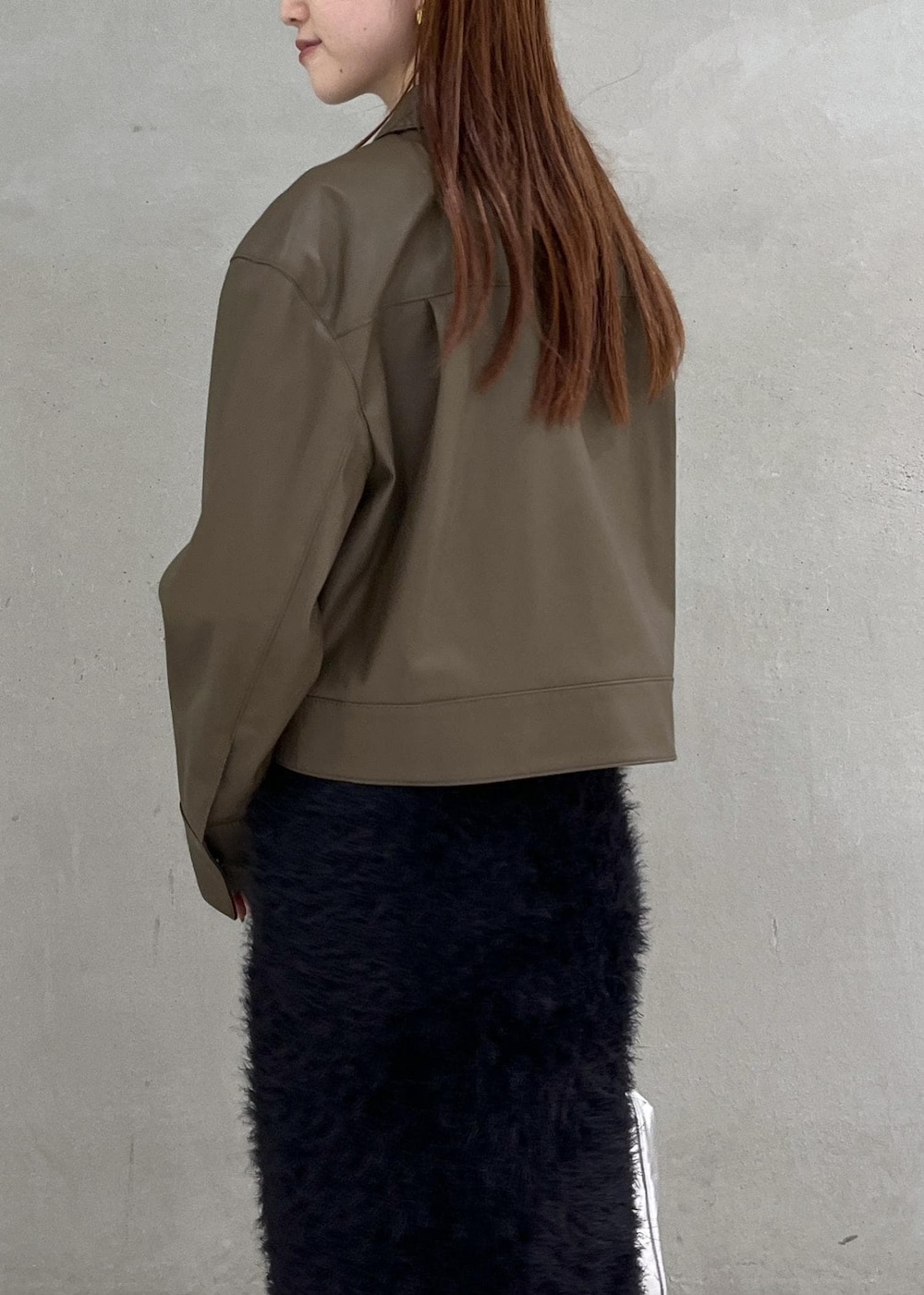 ブラウン系のブルゾン、シルバー系のボストンバッグ、ブラック系のスカートを着用したレディースの夏コーディネートの4枚目の写真