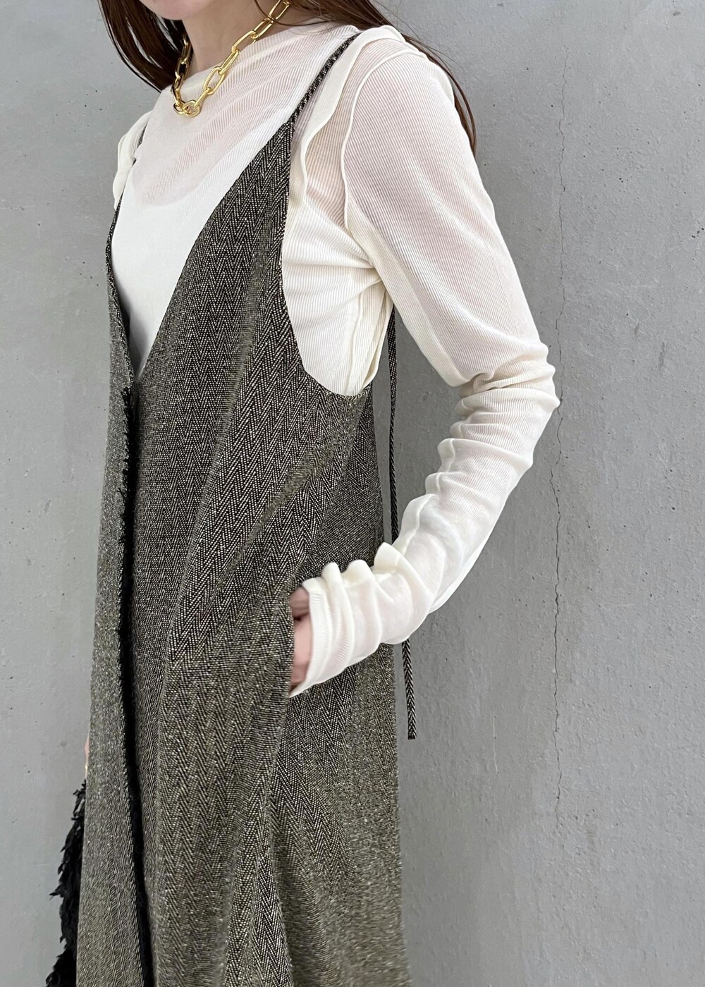 ブラック系のブーツ、ベージュ系のワンピース、ホワイト系のTシャツ/カットソーを着用したレディースの秋コーディネートの5枚目の写真