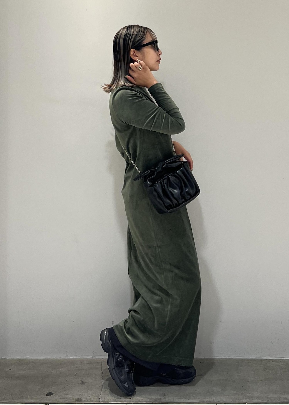 ブラック系のショルダーバッグ、ブラック系のスニーカー、ブラック系のスラックスを着用したレディースの秋コーディネートの4枚目の写真