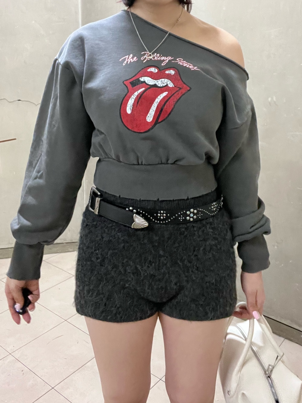 ブラック系のブーツ、ホワイト系のボストンバッグ、ブラック系のその他パンツを着用したレディースの冬コーディネートの4枚目の写真