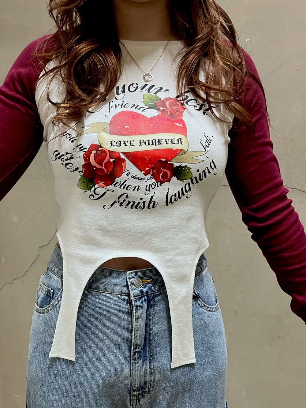 レッド系のTシャツ/カットソー、ブルー系のデニムパンツ、ブラック系のショルダーバッグを着用したレディースの春コーディネートの4枚目の写真