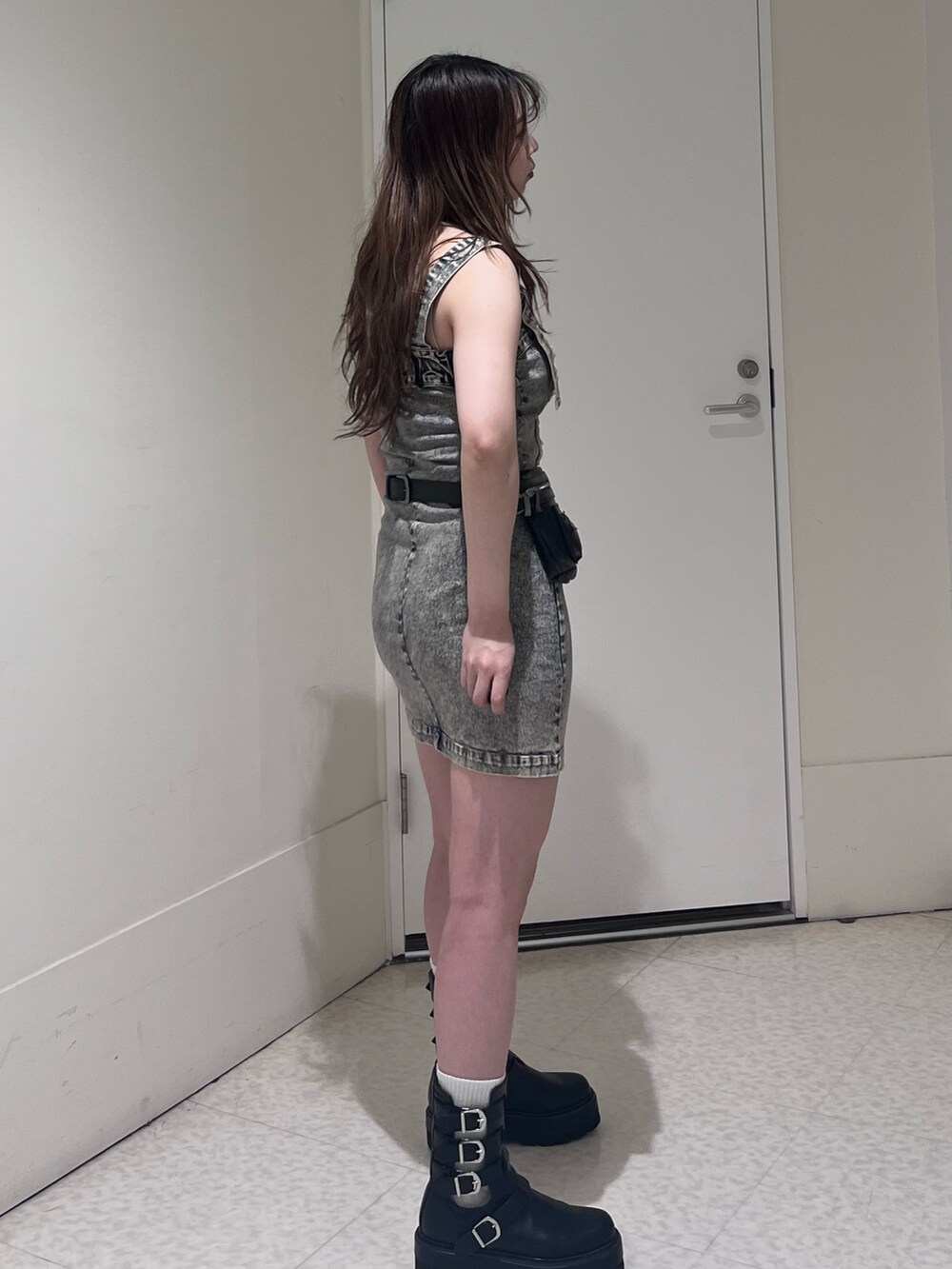 ベージュ系のワンピース、ブラック系のショルダーバッグ、ブラック系のブーツを着用したレディースの夏コーディネートの3枚目の写真