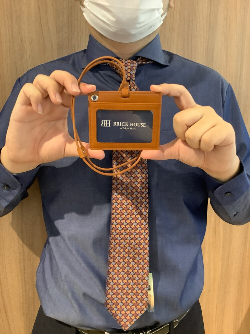 ブルー系のビジネスシャツ、ブラウン系のネクタイ、ブルー系のスラックスを着用したメンズの秋コーディネートの3枚目の写真