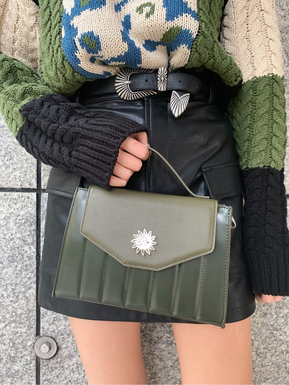 ブラック系のブーツ、ホワイト系のブルゾン、ブラック系のニット/セーターを着用したレディースの冬コーディネートの6枚目の写真