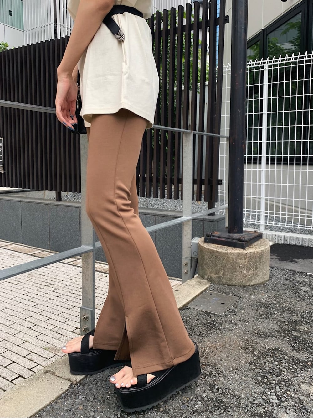 ブラック系のサンダル、ホワイト系のTシャツ/カットソー、ブラック系のベルトを着用したレディースの夏コーディネートの6枚目の写真