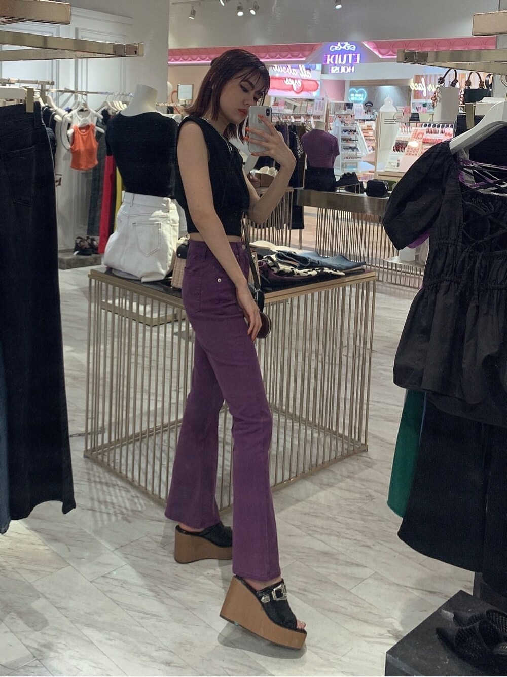 ブラック系のサンダル、パープル系のデニムパンツ、ブラック系のTシャツ/カットソーを着用したレディースの夏コーディネートの2枚目の写真