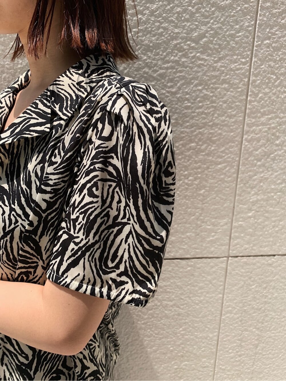 ブラック系のブーツ、ブラック系のデニムパンツ、ホワイト系のシャツ/ブラウスを着用したレディースの夏コーディネートの5枚目の写真