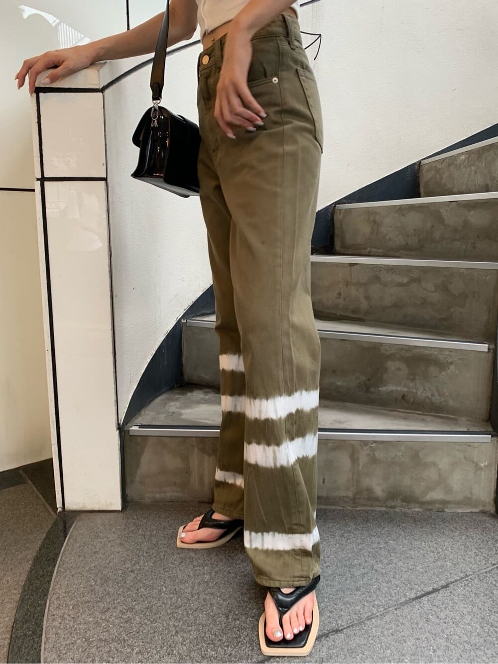 ホワイト系のTシャツ/カットソー、ブラック系のサンダル、ブラック系のショルダーバッグを着用したレディースの夏コーディネートの6枚目の写真