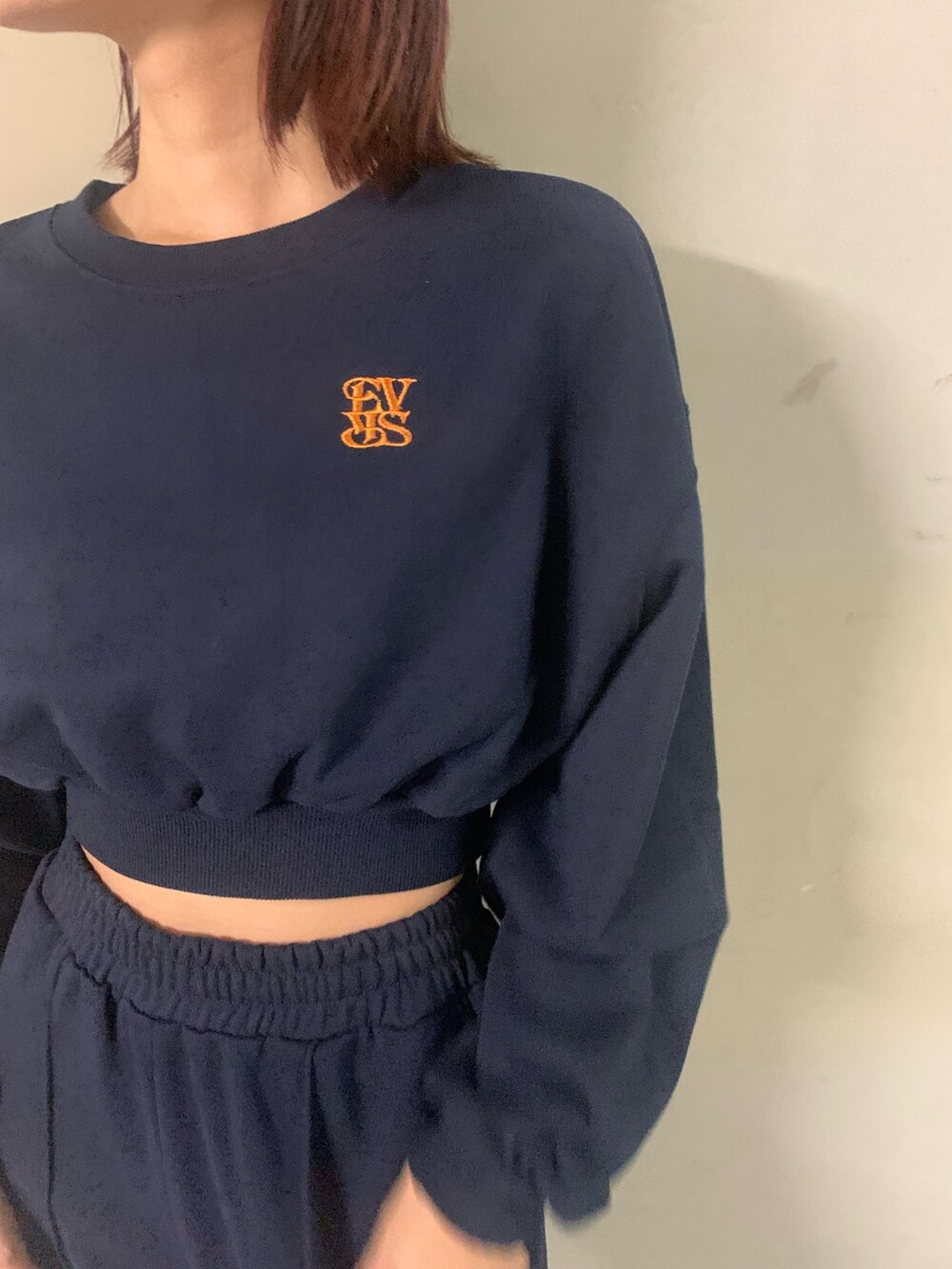 ブルー系のスウェット、ブルー系のスウェットパンツ、ホワイト系のハンドバッグを着用したレディースの秋コーディネートの5枚目の写真