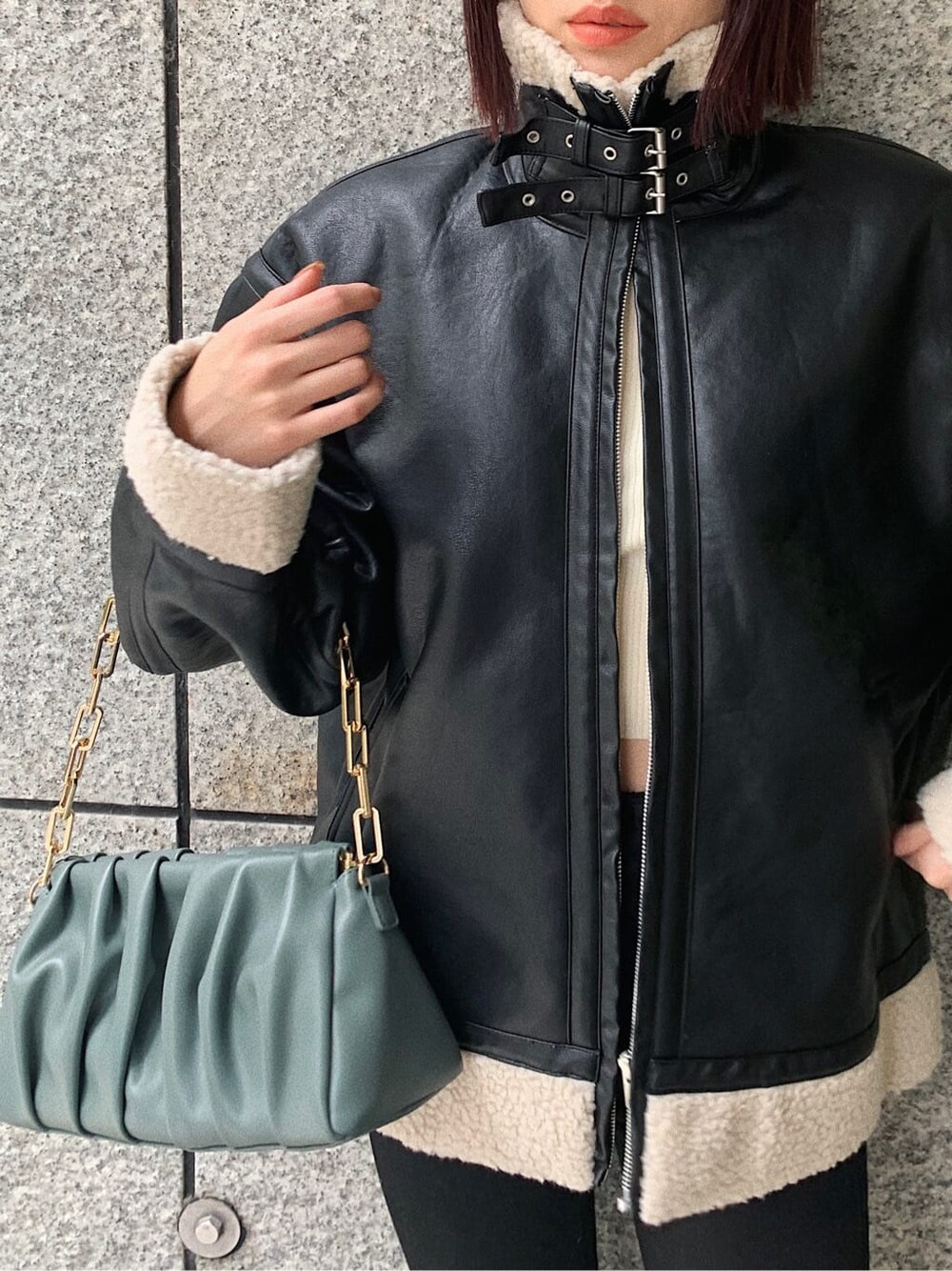 ブラック系のデニムパンツ、ブラック系のブルゾン、その他のブーツを着用したレディースの冬コーディネートの3枚目の写真