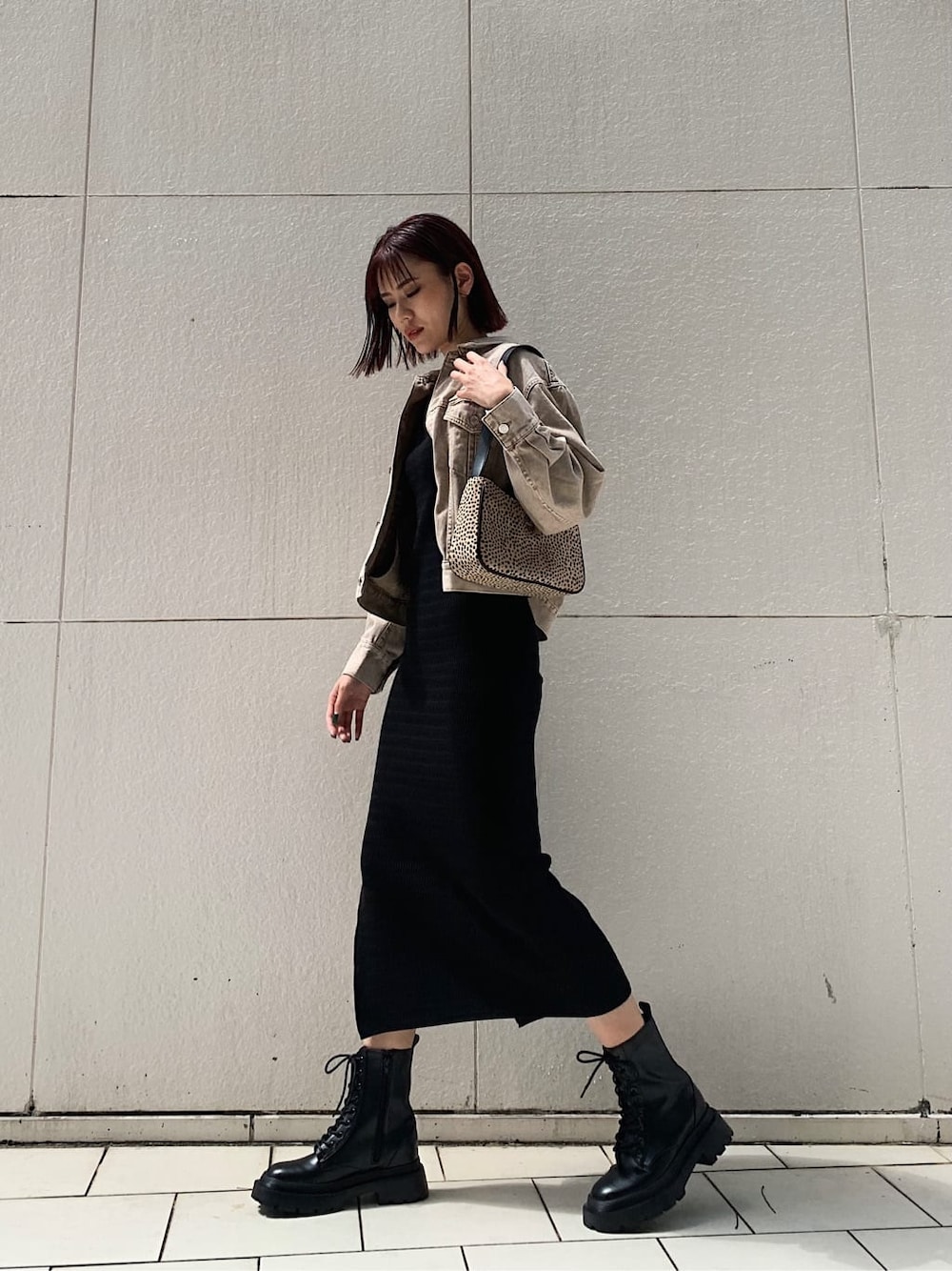 ベージュ系のデニムジャケット、ブラック系のブーツ、その他のショルダーバッグを着用したレディースの秋コーディネートの2枚目の写真