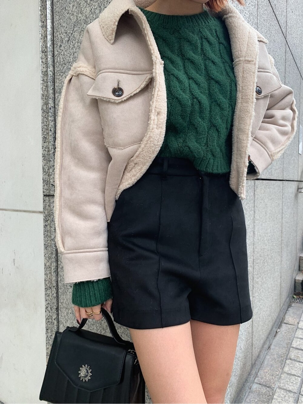 ブラック系のブーツ、ブラック系のその他パンツ、グリーン系のニット/セーターを着用したレディースの秋コーディネートの3枚目の写真