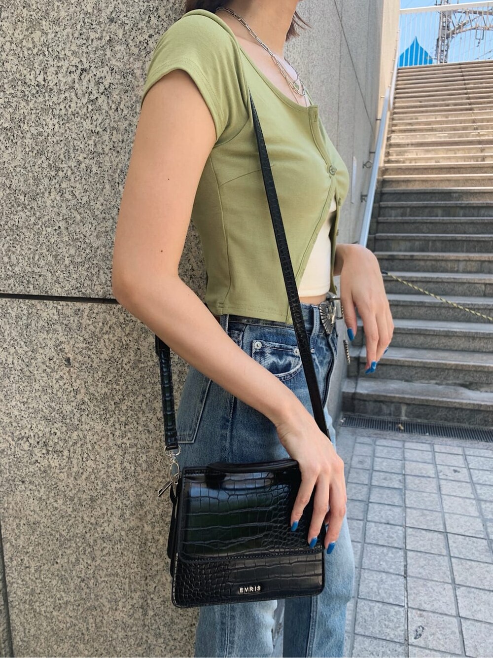 グリーン系のTシャツ/カットソー、ブルー系のデニムパンツ、ブラック系のサンダルを着用したレディースの夏コーディネートの7枚目の写真