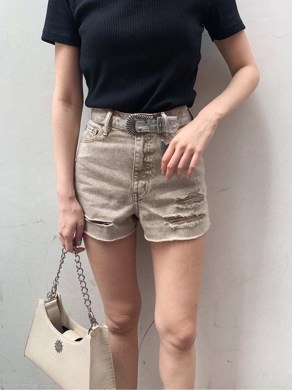イエロー系のサンダル、ベージュ系のデニムパンツ、ブラック系のTシャツ/カットソーを着用したレディースの春コーディネートの3枚目の写真