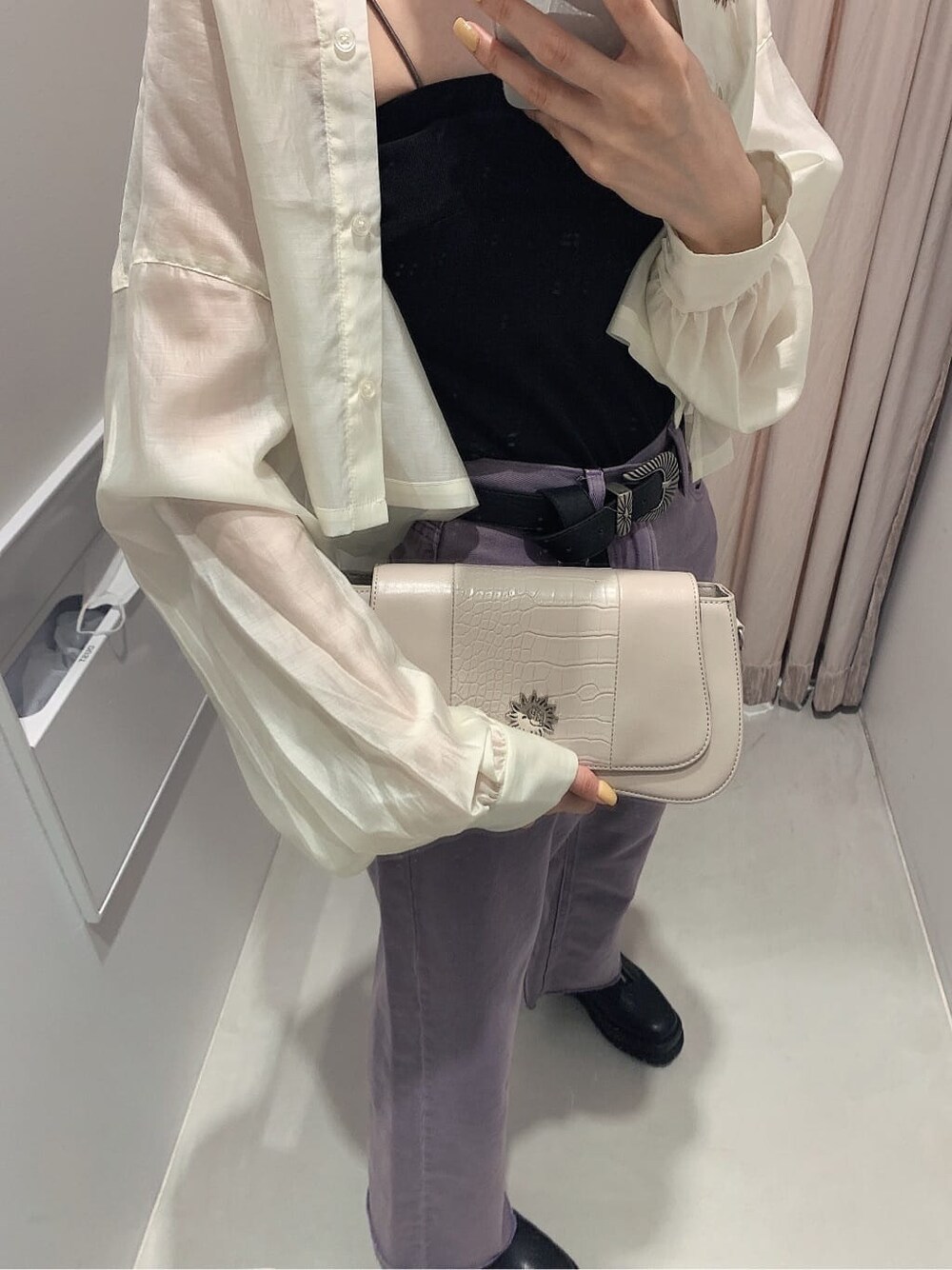 ブラック系のブーツ、ブラック系のキャミソール、パープル系のデニムパンツを着用したレディースの春コーディネートの7枚目の写真