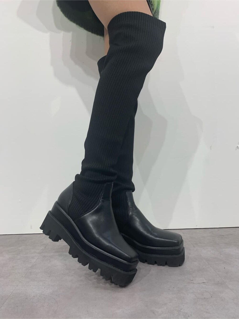 グリーン系のカーディガン/ボレロ、ブラック系のブーツ、ブラック系のショルダーバッグを着用したレディースの秋コーディネートの9枚目の写真