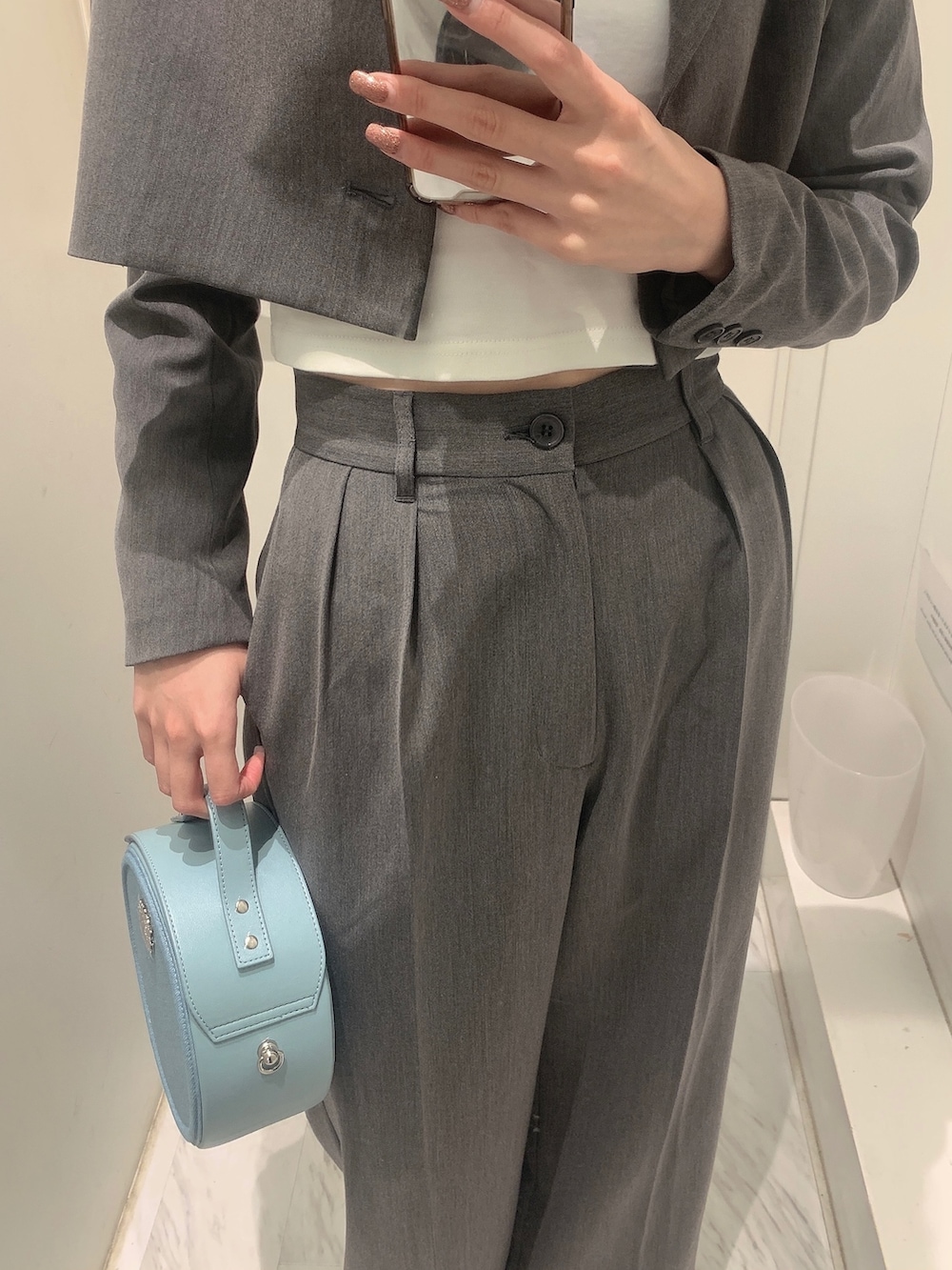 グレー系のその他パンツ、グレー系のテーラードジャケット、ブルー系のショルダーバッグを着用したレディースの春コーディネートの6枚目の写真