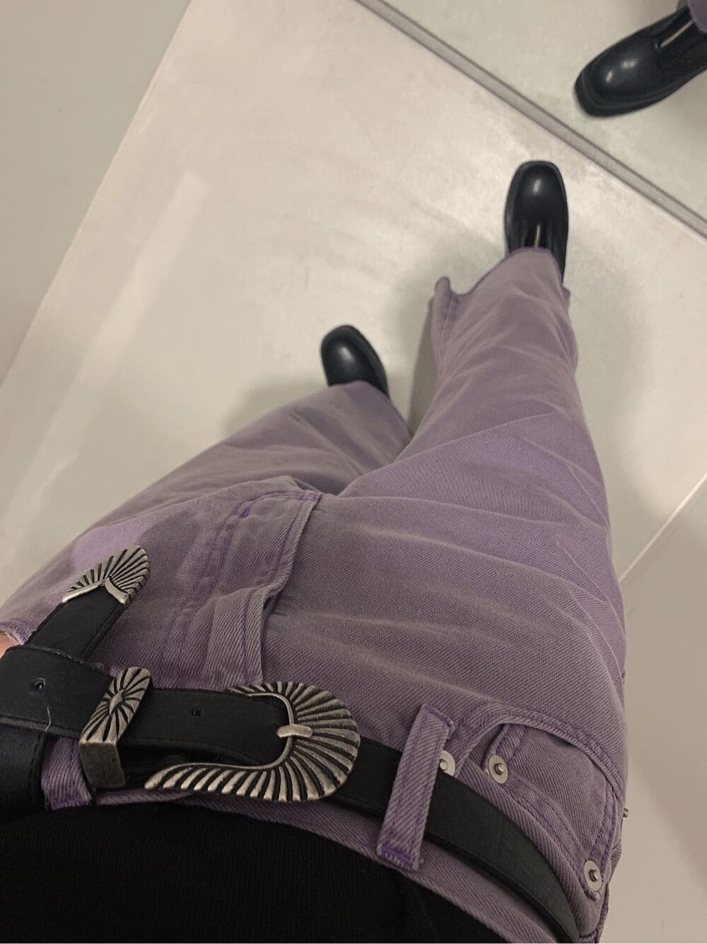 ブラック系のブーツ、ブラック系のキャミソール、パープル系のデニムパンツを着用したレディースの春コーディネートの5枚目の写真