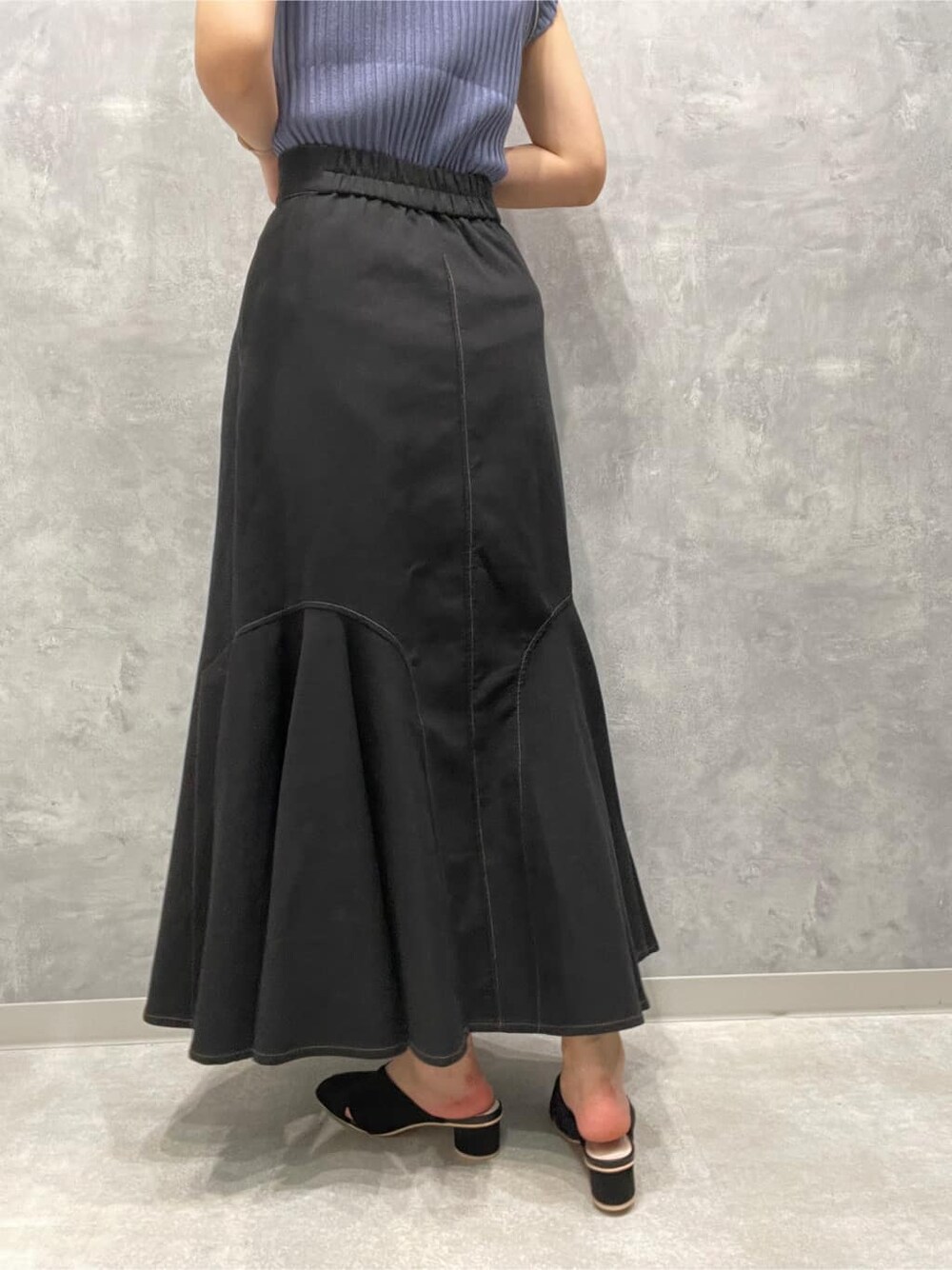 ブラック系のサンダル、ブラック系のスカート、ブルー系のニット/セーターを着用したレディースの夏コーディネートの9枚目の写真