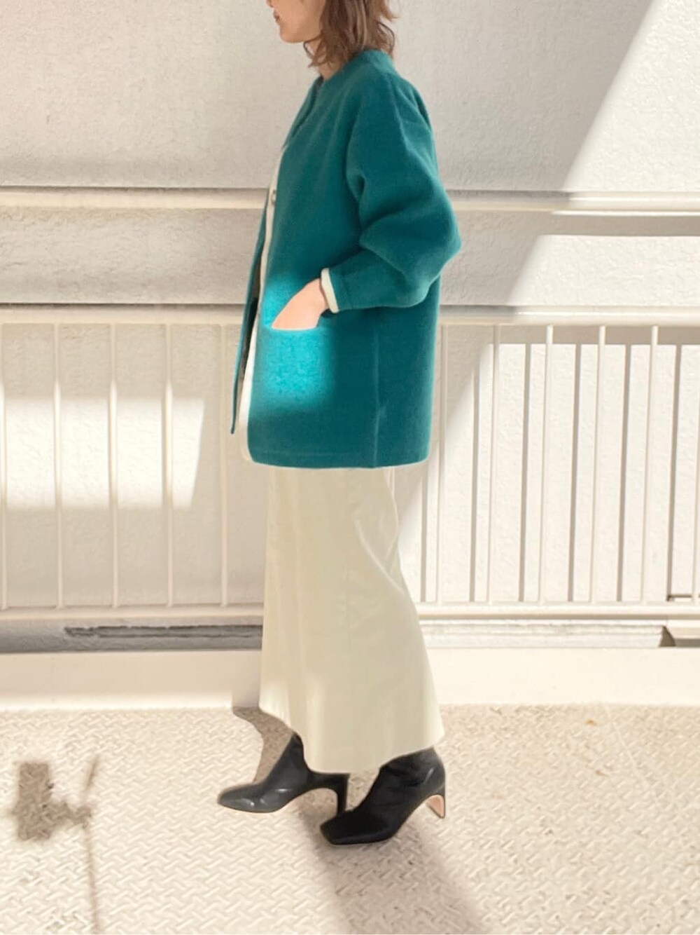 ブラック系のその他シューズ、ホワイト系のスカート、ホワイト系のニット/セーターを着用したレディースの冬コーディネートの3枚目の写真