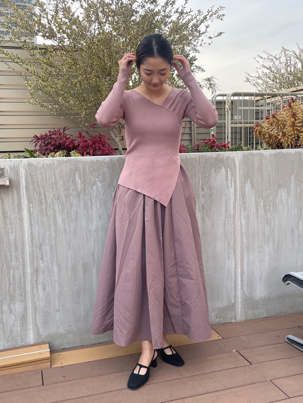 ホワイト系のトレンチコート、ブラック系のパンプス、ピンク系のワンピースを着用したレディースの冬コーディネートの8枚目の写真