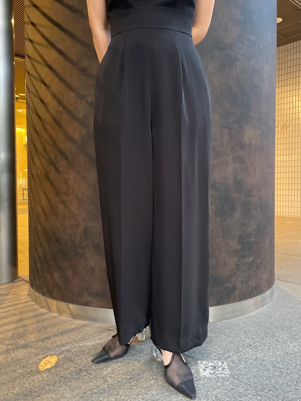 ブラック系のパンプス、ブラック系のパンツドレスを着用したレディースの秋コーディネートの10枚目の写真