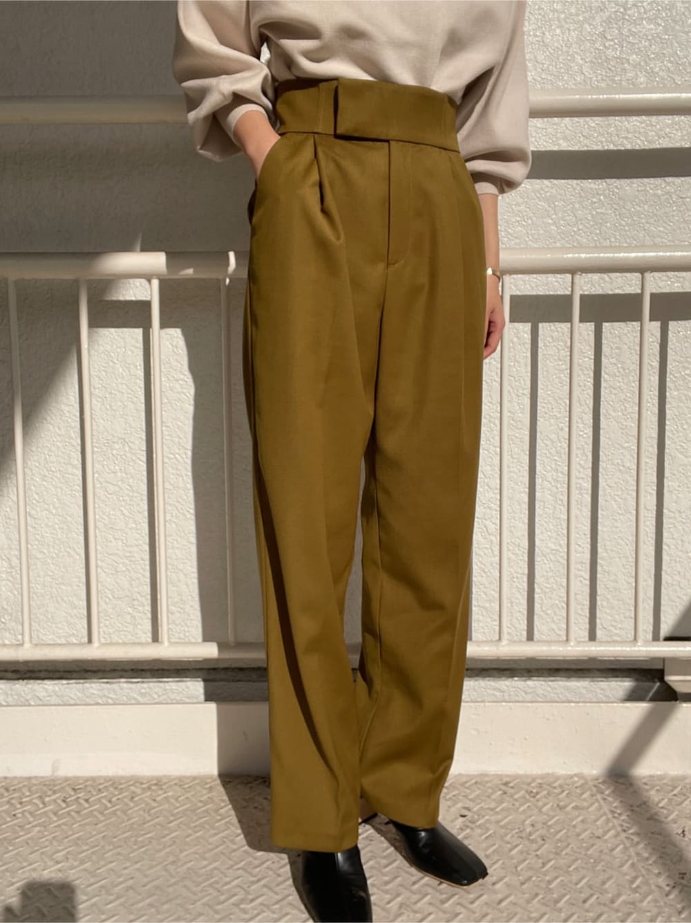 ブラック系のその他シューズ、グリーン系のその他パンツ、ホワイト系のニット/セーターを着用したレディースの冬コーディネートの8枚目の写真