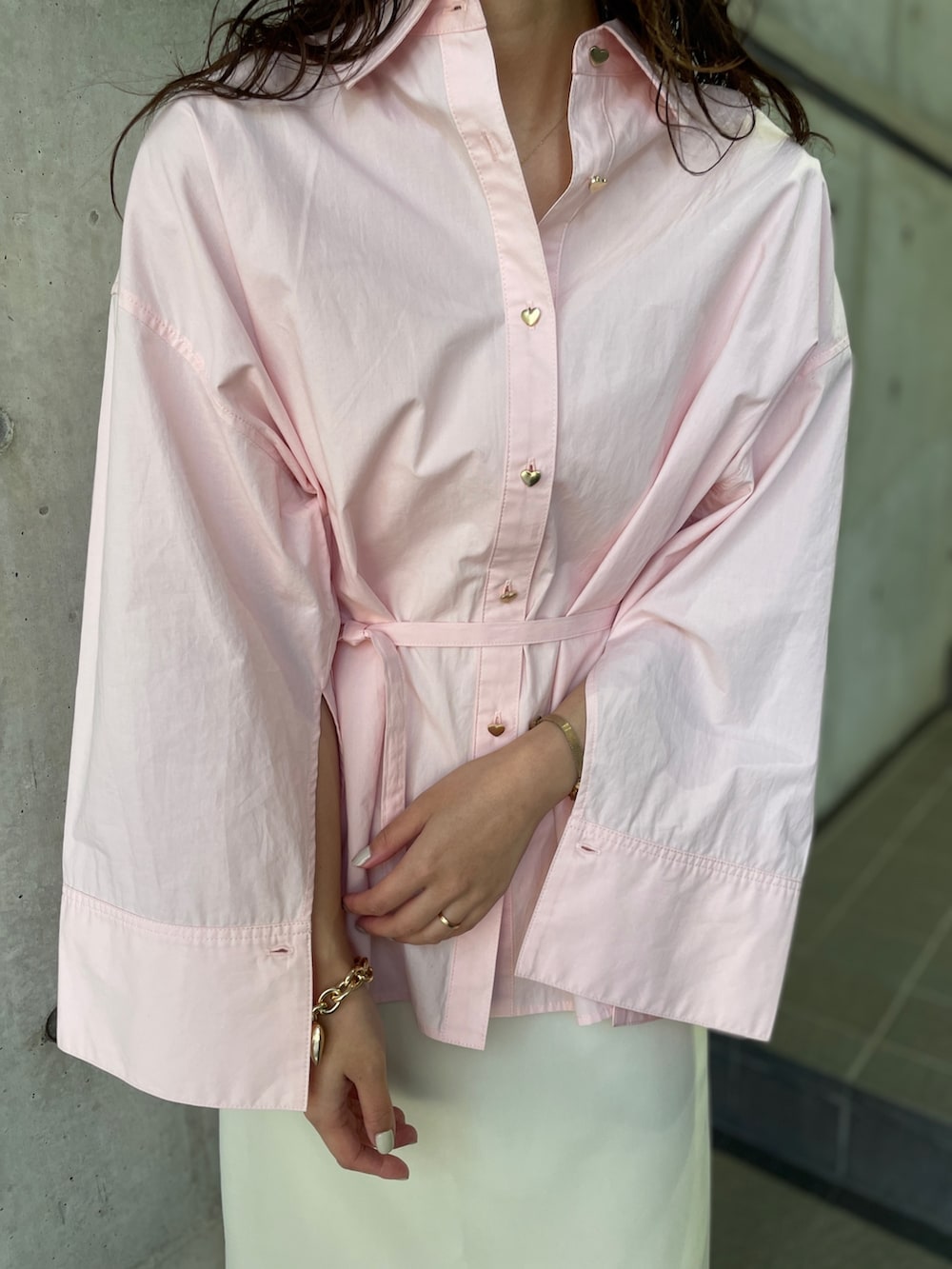 ピンク系のシャツ/ブラウス、ブラック系のパンプス、ホワイト系のスカートを着用したレディースの冬コーディネートの9枚目の写真